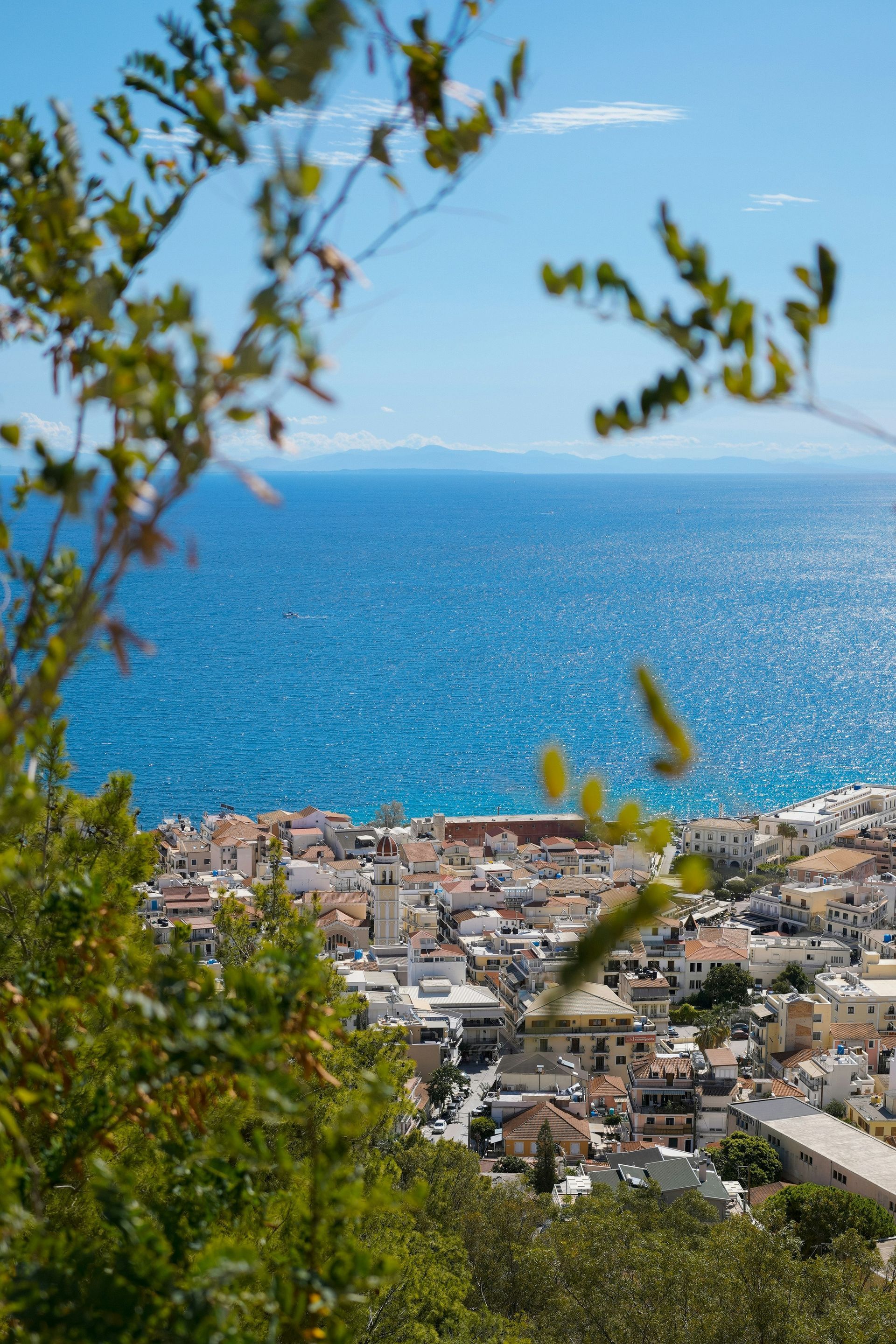 A view of a city and the ocean from a hill in Zakynthos, Greece.