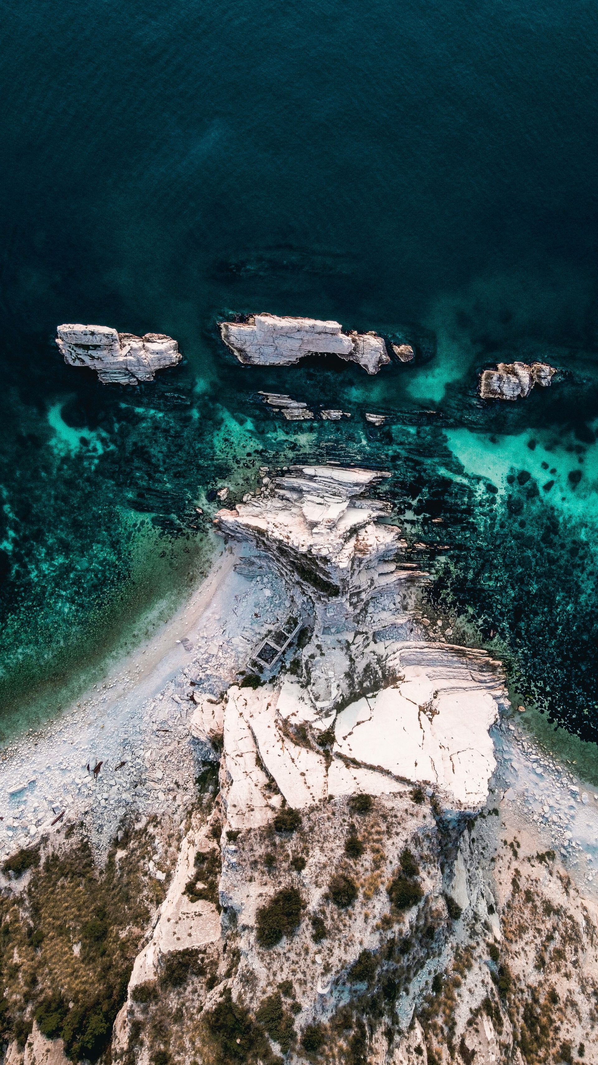 An aerial view of a small island in the middle of the ocean in Sirolo, Italy.