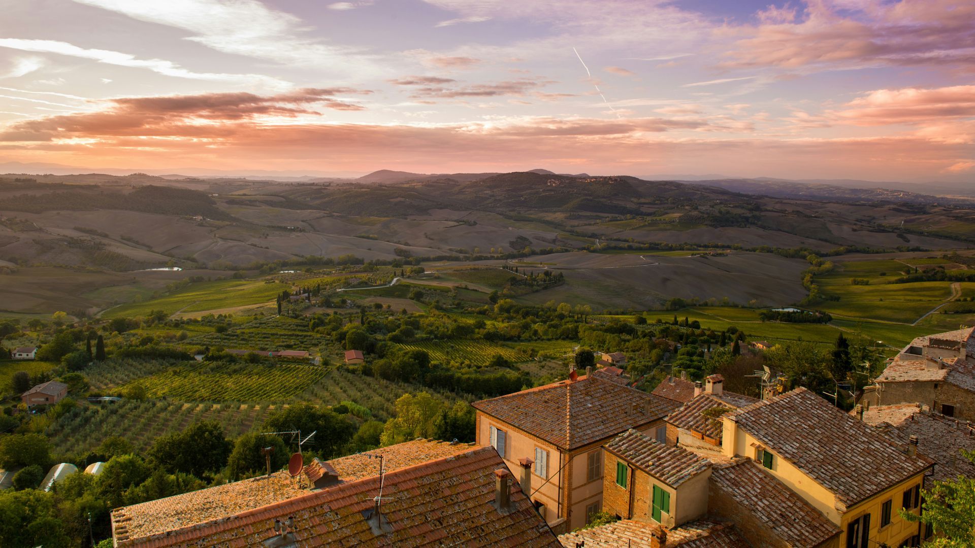 An aerial view of a village in the countryside at sunset in Provence, France.