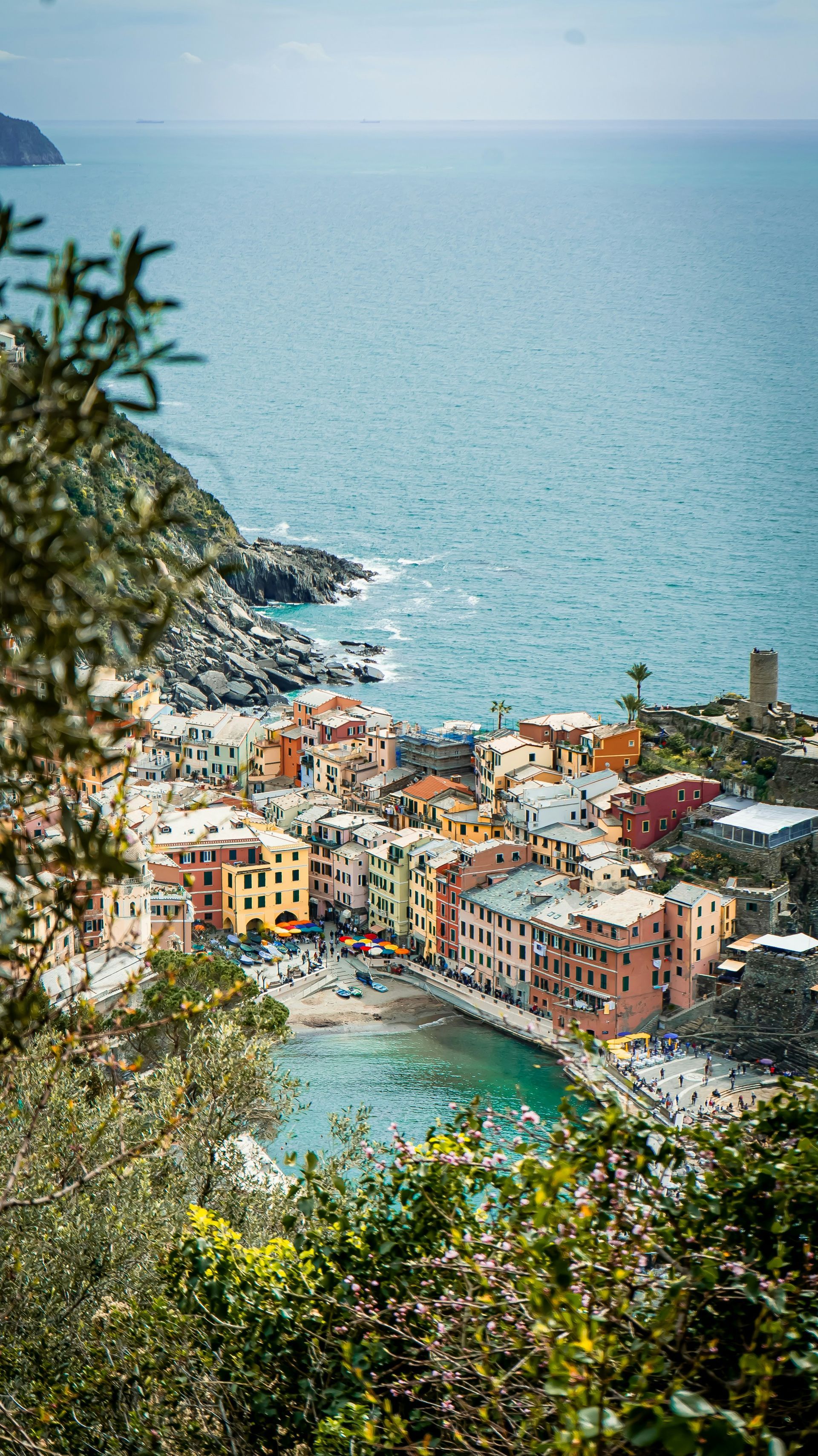 An aerial view of a small town next to the ocean in Cinque Terre, Italy.