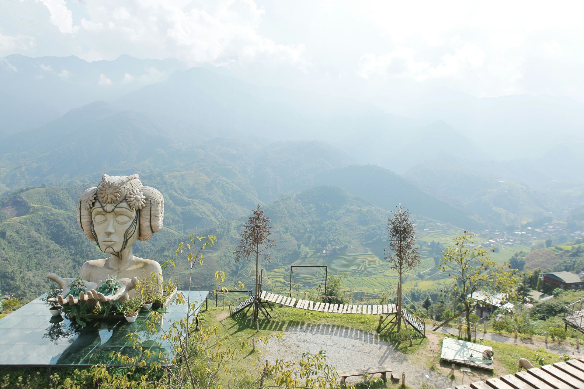 Statue overlooking a mountain range on a sunny day in Sapa, Vietnam. 