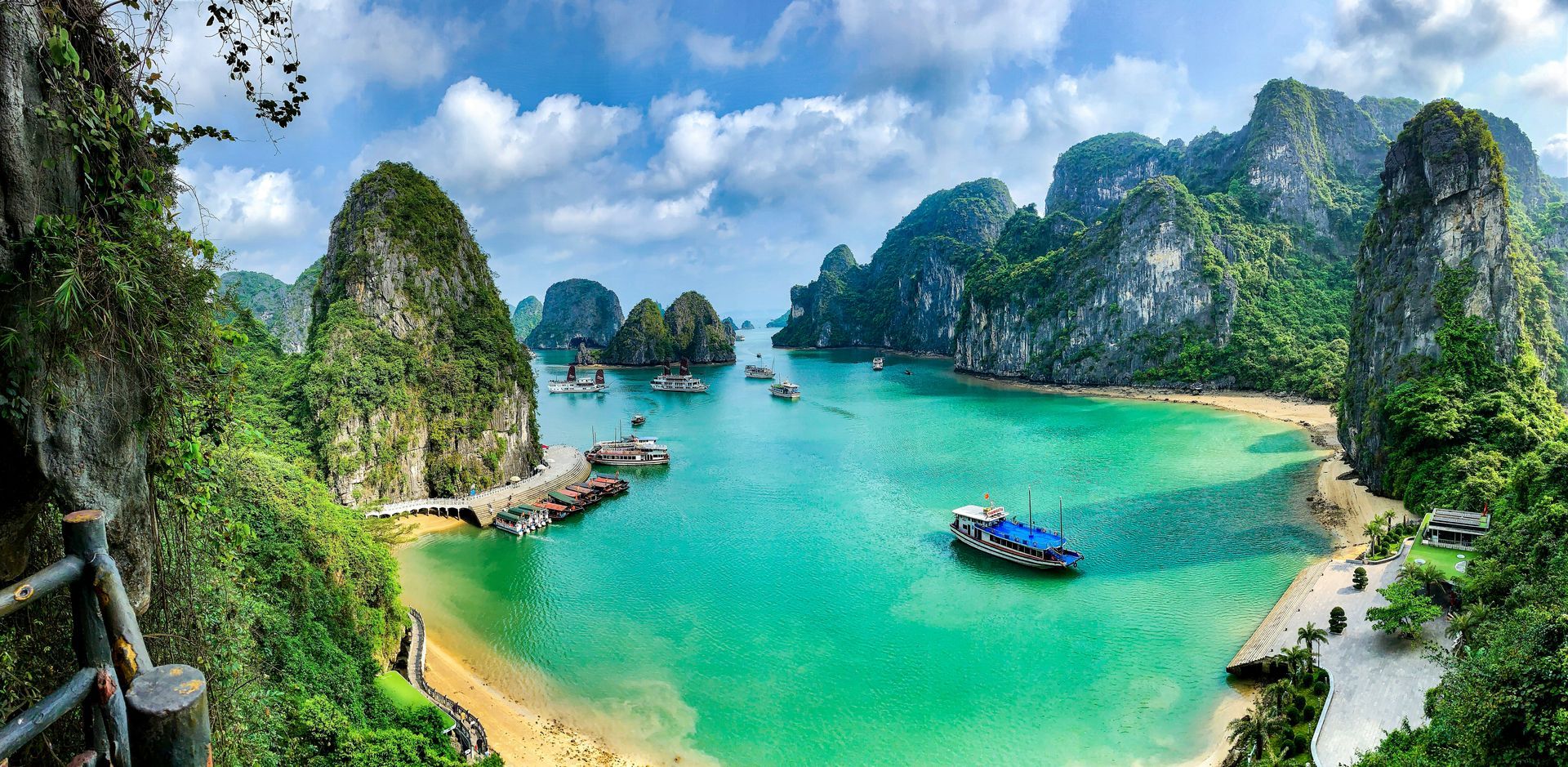 Scenic view of Ha Long Bay, Vietnam, with emerald waters, limestone karsts, and boats.