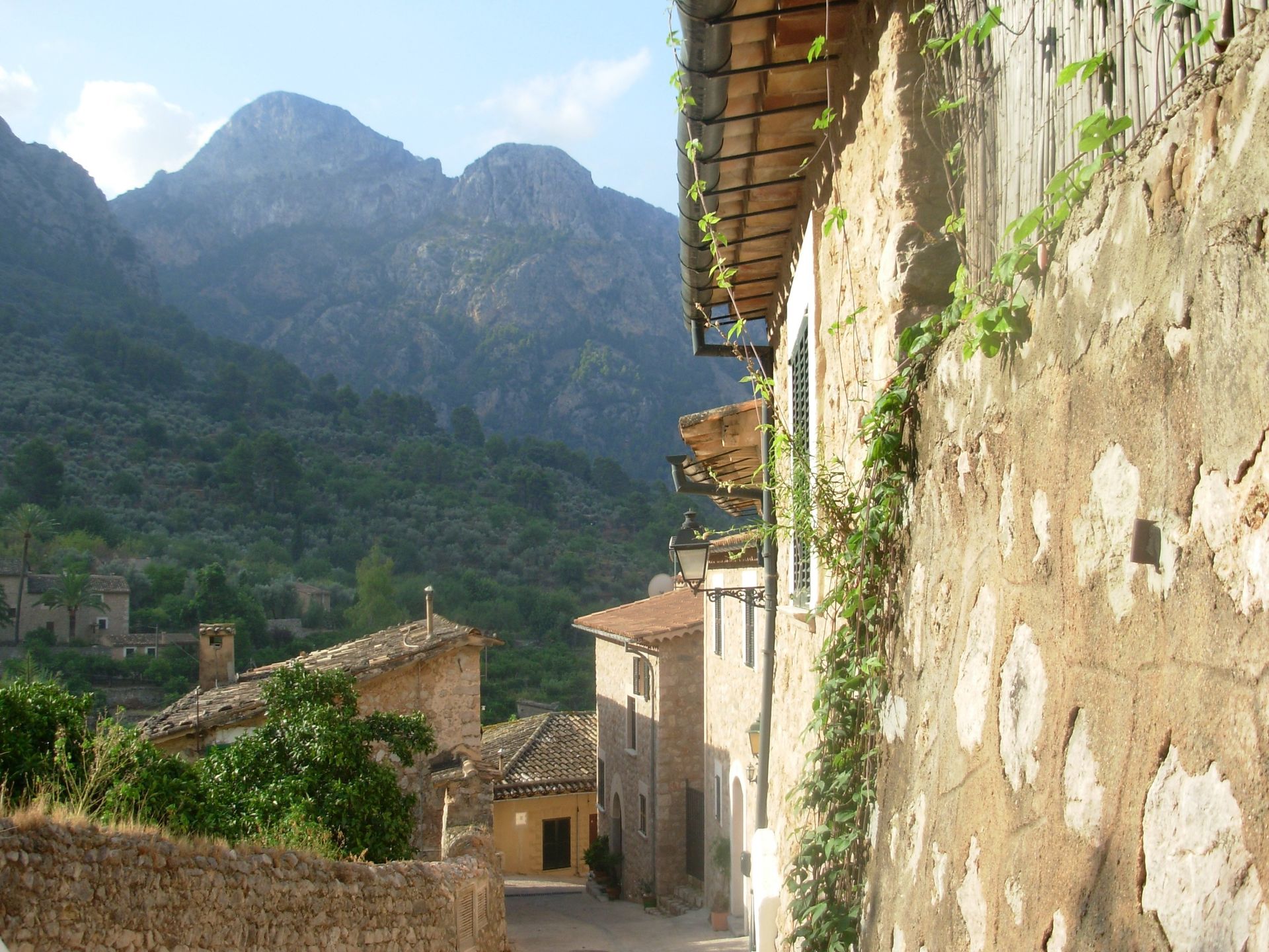 A narrow street with a mountain in the background in Mallorca, Spain.
