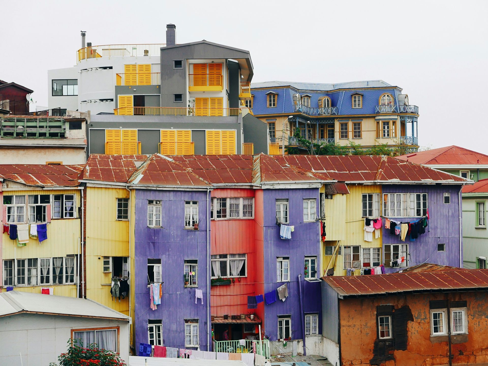 Colorful buildings on a hillside, laundry hangs in Valparaíso, Chile.