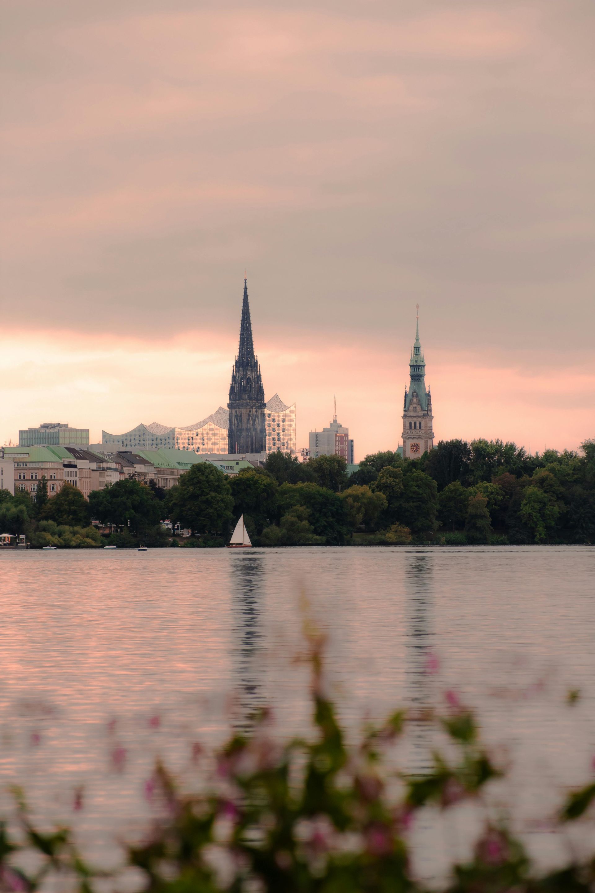 The Saalburg, Germany's skyline is reflected in a lake at sunset.