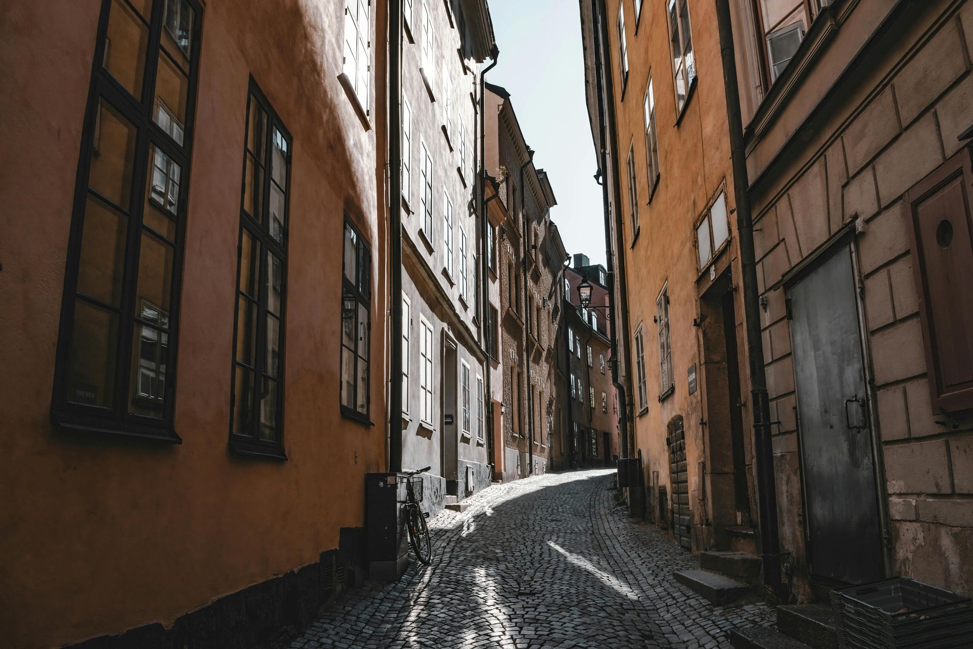 A narrow cobblestone street between two buildings in Stockholm, Sweden. 