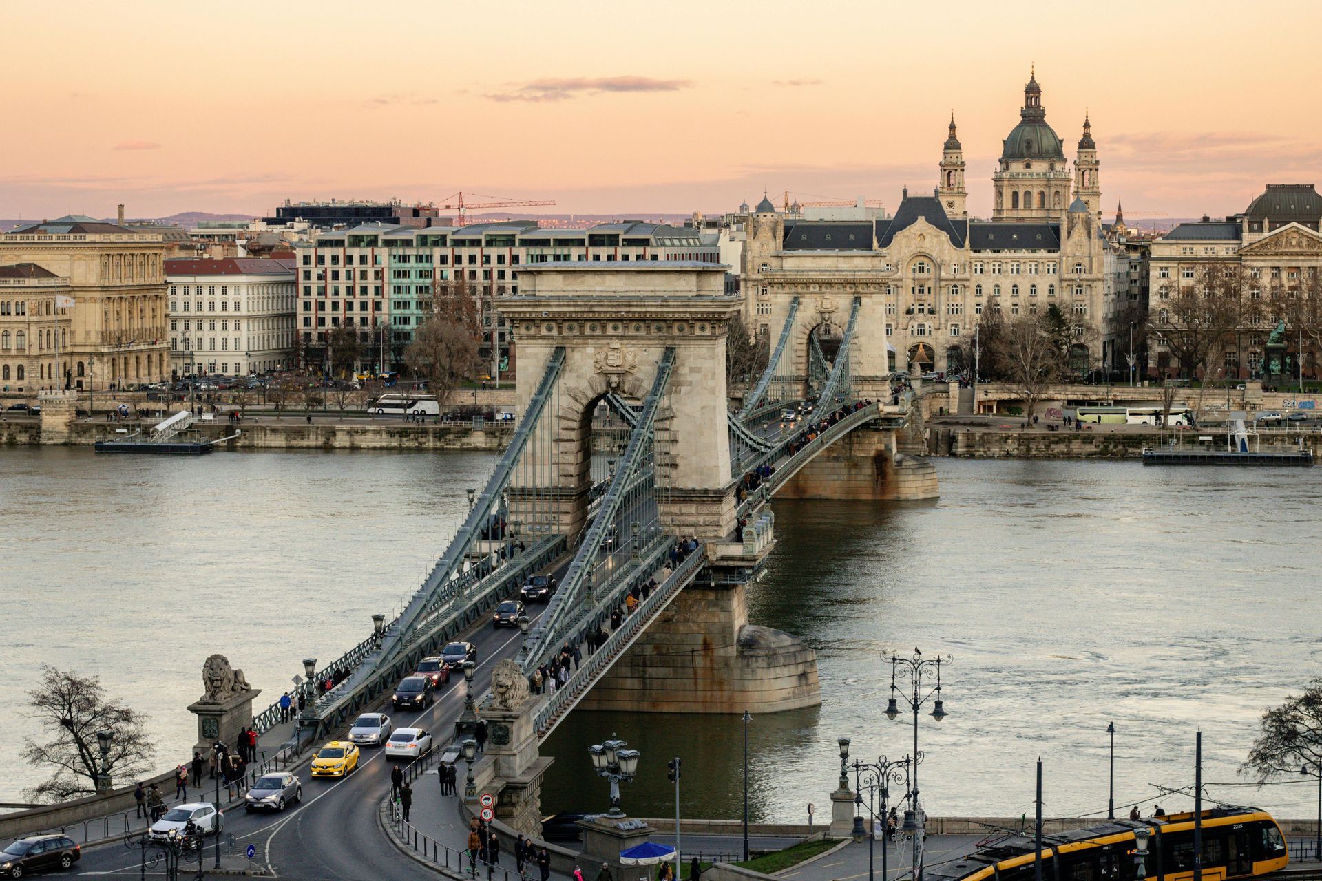 A bridge over the Danube River with a city in the background