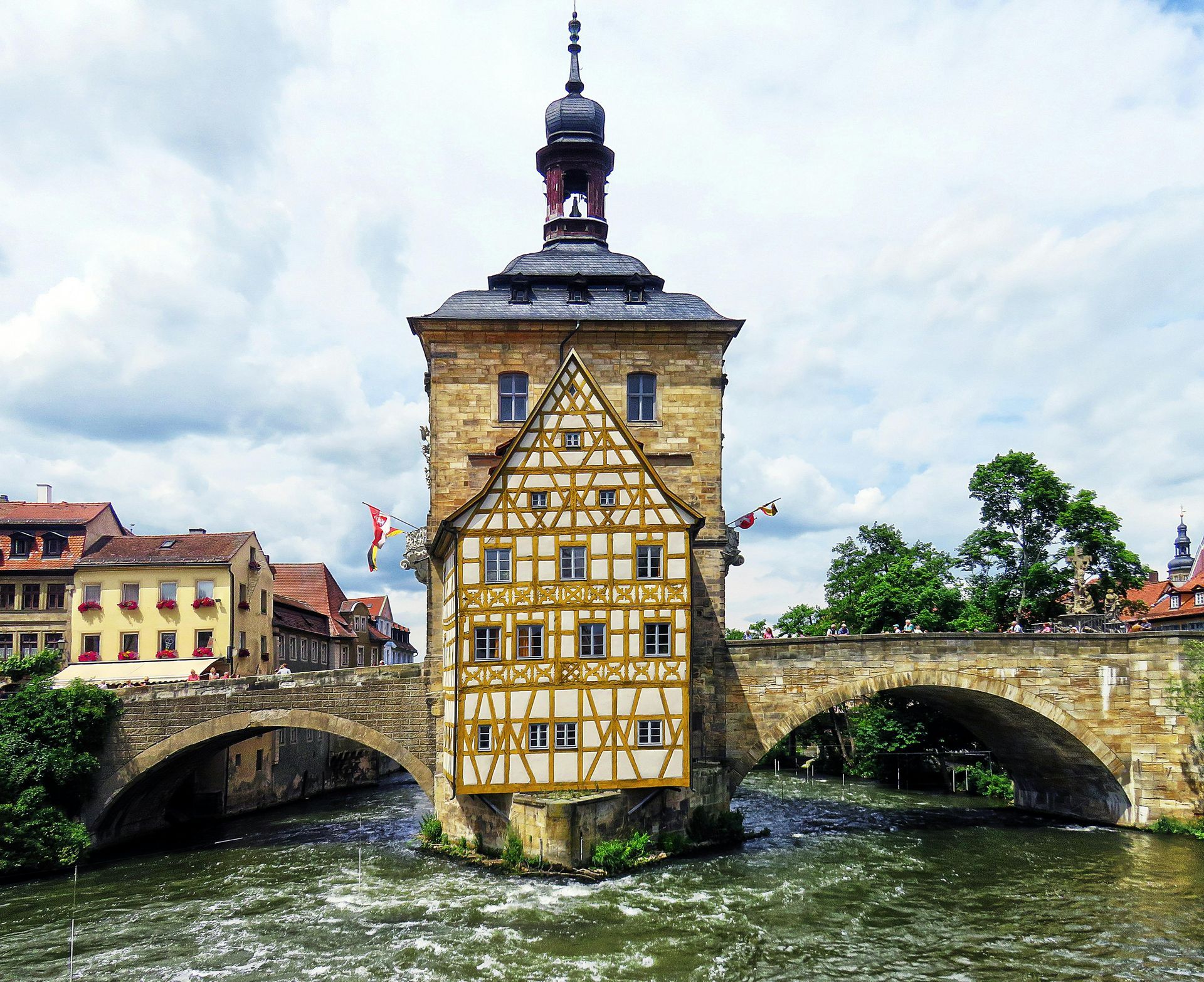 A bridge over a river with a tower in the foreground in Bamberg, Germany.