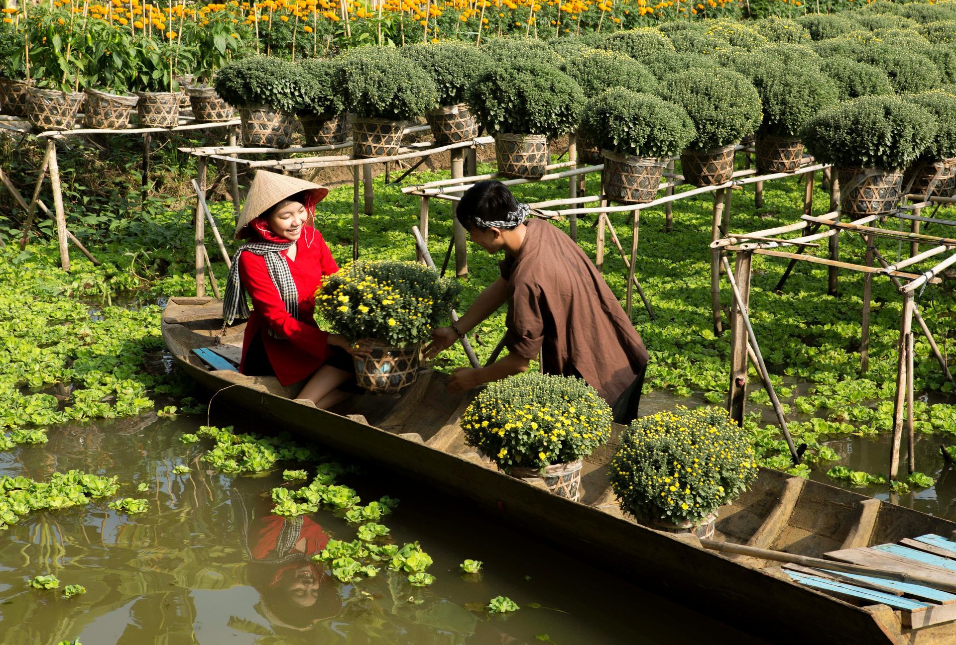 A man and a woman are in a boat in the Mekong River.