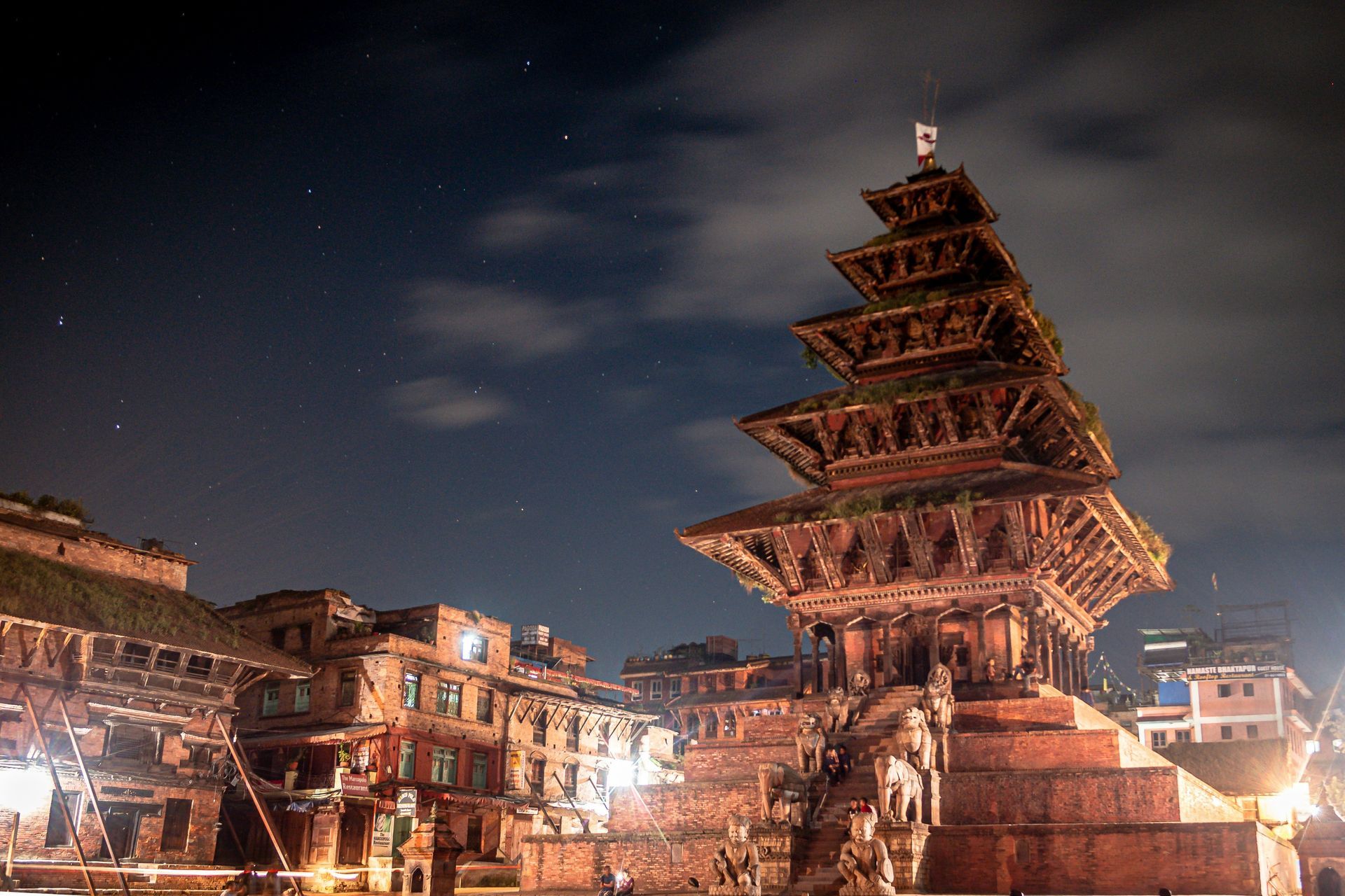 A multi-tiered temple illuminated at night in the square of Bhaktapur, Nepal.