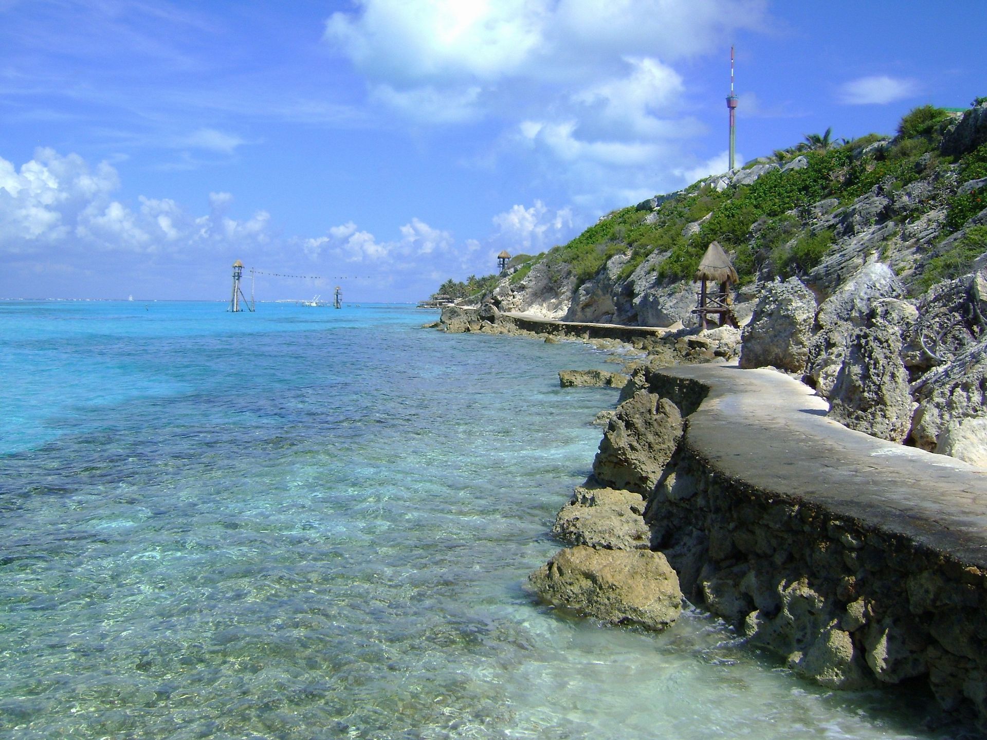 A rocky shoreline with a path leading to the ocean on Cozumel island in Mexico.