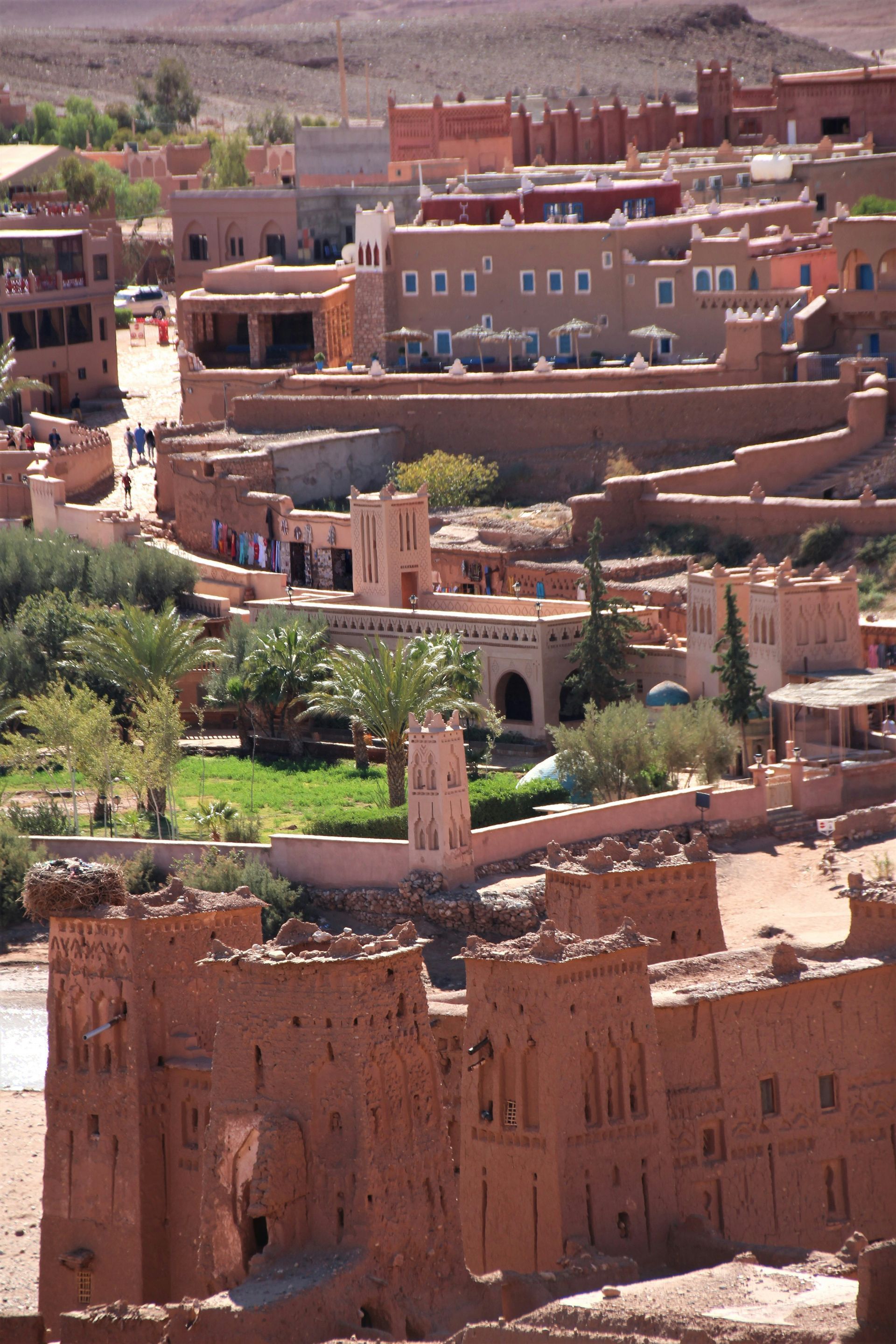 An aerial view of the city of Ouarzazate, Morocco, with a clock tower in the middle.