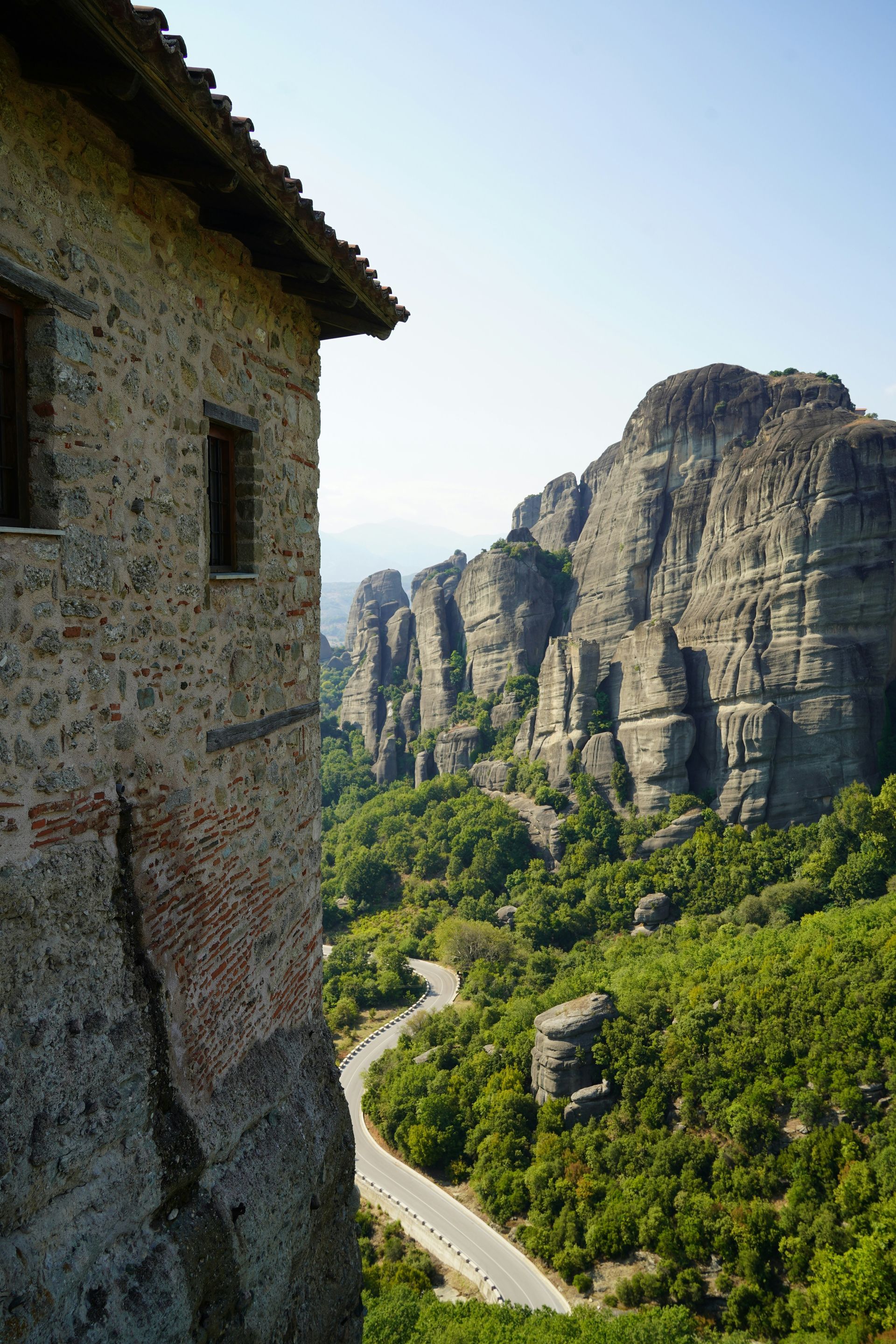 There is a road going through the mountains in the background in Kalabaka, Greece.