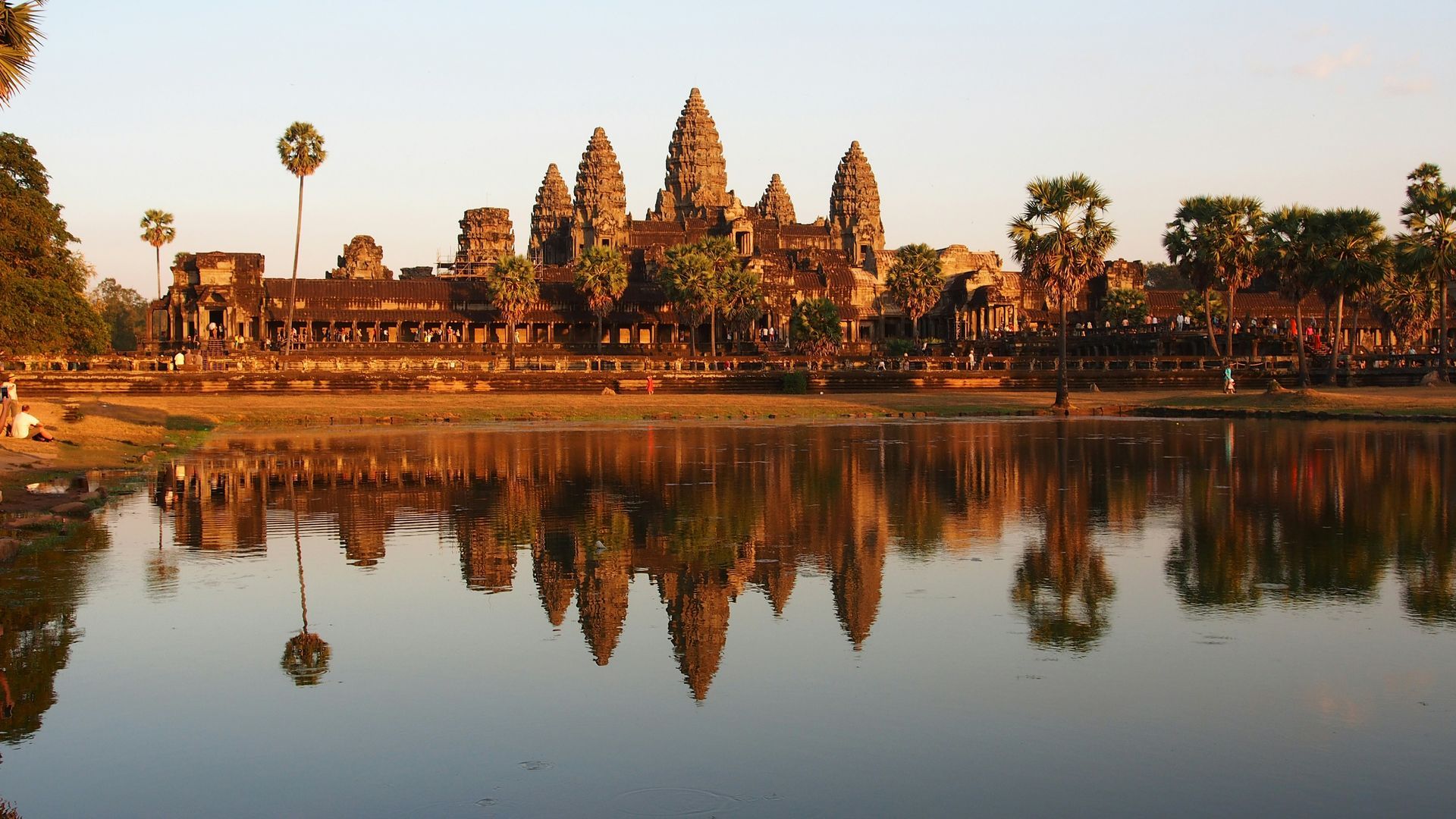 Angkor Wat temple reflecting in the water at sunset, Cambodia.