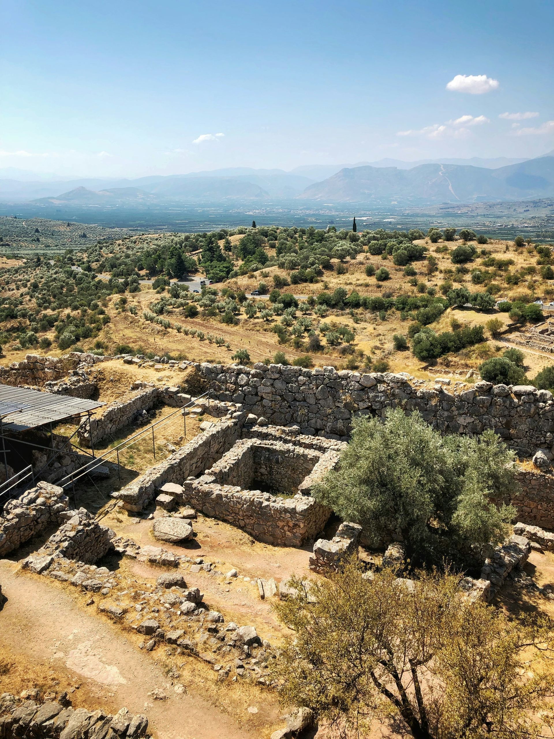 An aerial view of a ruined building in the middle of a field in Mycenae, Greece.