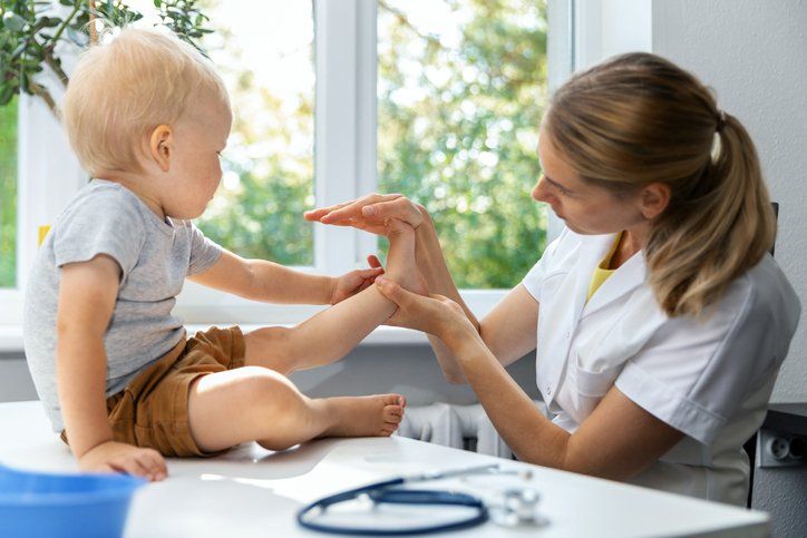 Female Orthopedist Examining Little Child Foot Condition in Clinic | Central Coast, Nsw | Angela Green Podiatry