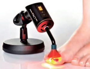 Black pedicure foot spa massaging toes with red light at a salon-like setting