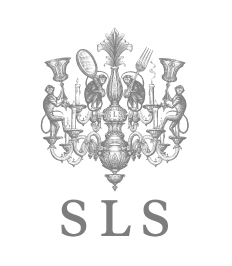 Elaborate chandelier with monkey figures, mirror, and fork, SLS initials below.