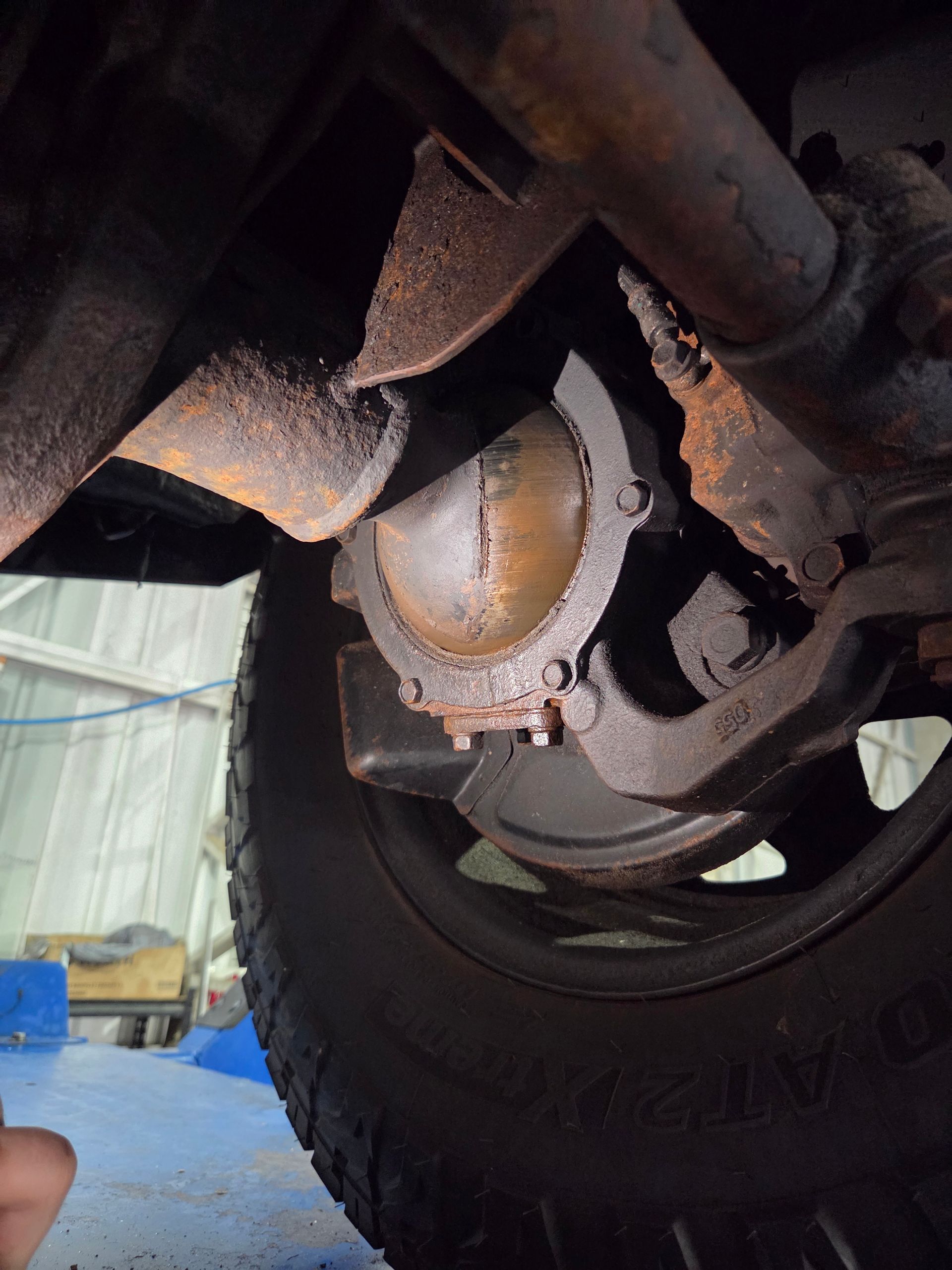 A Man Is Working On The Engine Of A Car With A Wrench — Bay City Quality Mobile Mechanic In Pialba, QLD