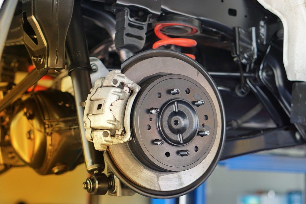 A Close Up Of A Car 's Brake System On A Lift — Bay City Quality Mobile Mechanic In Pialba, QLD