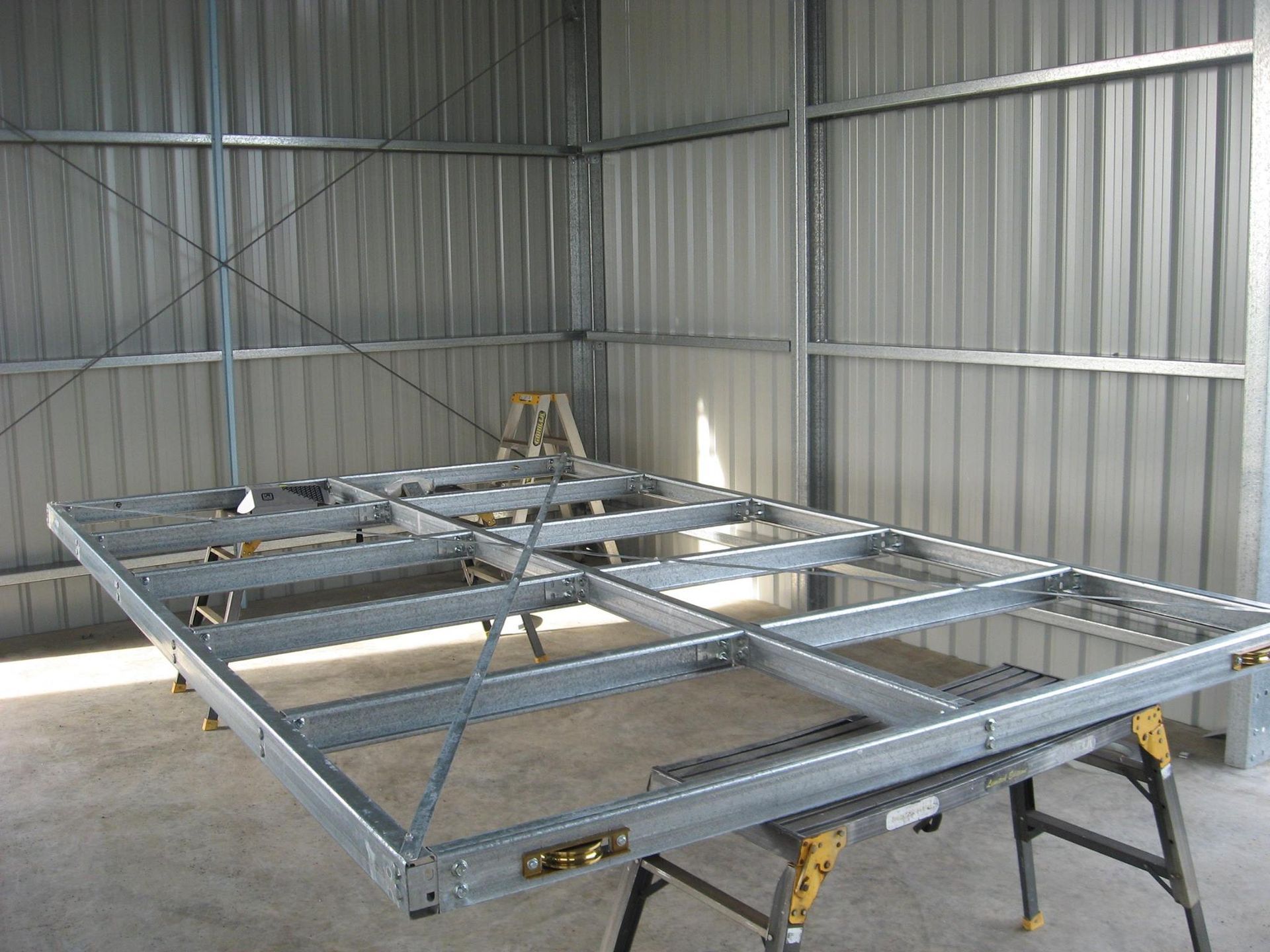 A Metal Frame Is Sitting On A Table In A Shed — Bushman Sheds in Bundaberg East, QLD