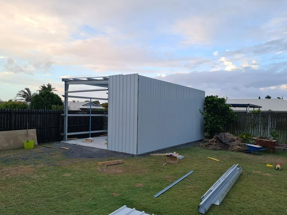 A Large Metal Structure Is Being Built In A Garage — Bushman Sheds in Bundaberg East, QLD