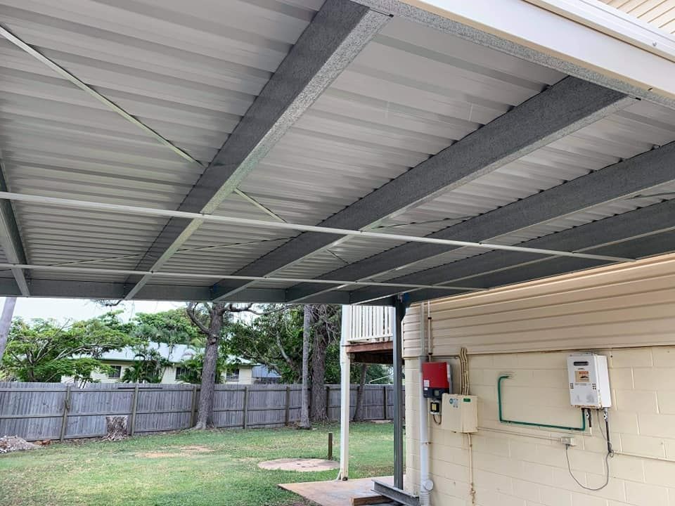 There Is A Carport In The Backyard Of A House — Bushman Sheds in South Kolan, QLD