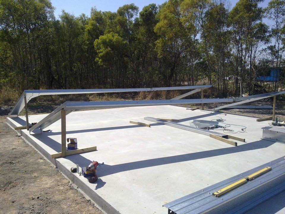 A Metal Structure Is Being Built On A Concrete Surface — Bushman Sheds in Bundaberg East, QLD