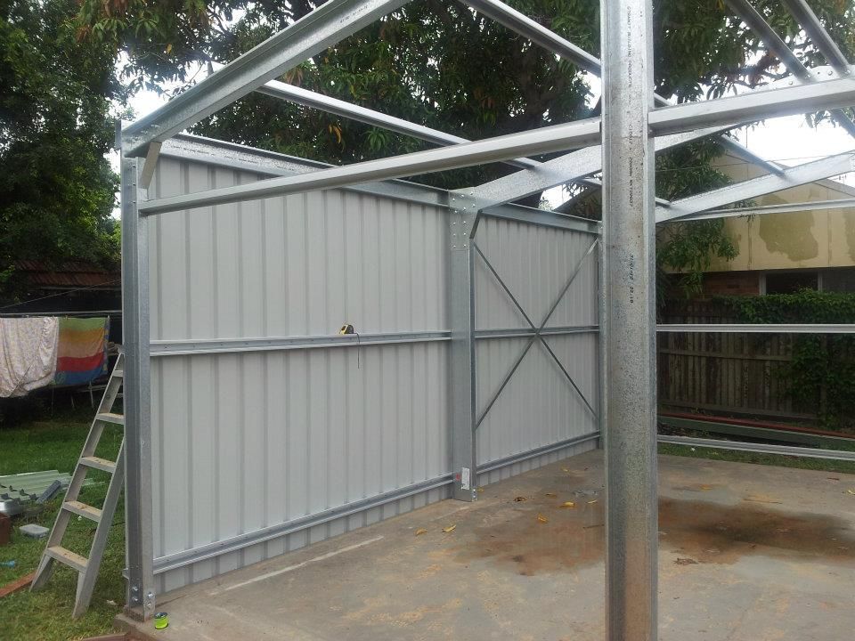 A Metal Structure Is Being Built In A Backyard — Bushman Sheds in Bundaberg East, QLD