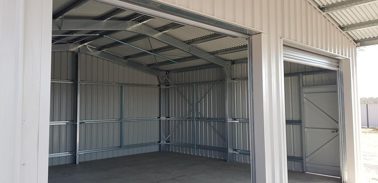 The Inside Of A Metal Garage With The Doors Open — Bushman Sheds in Bundaberg, QLD