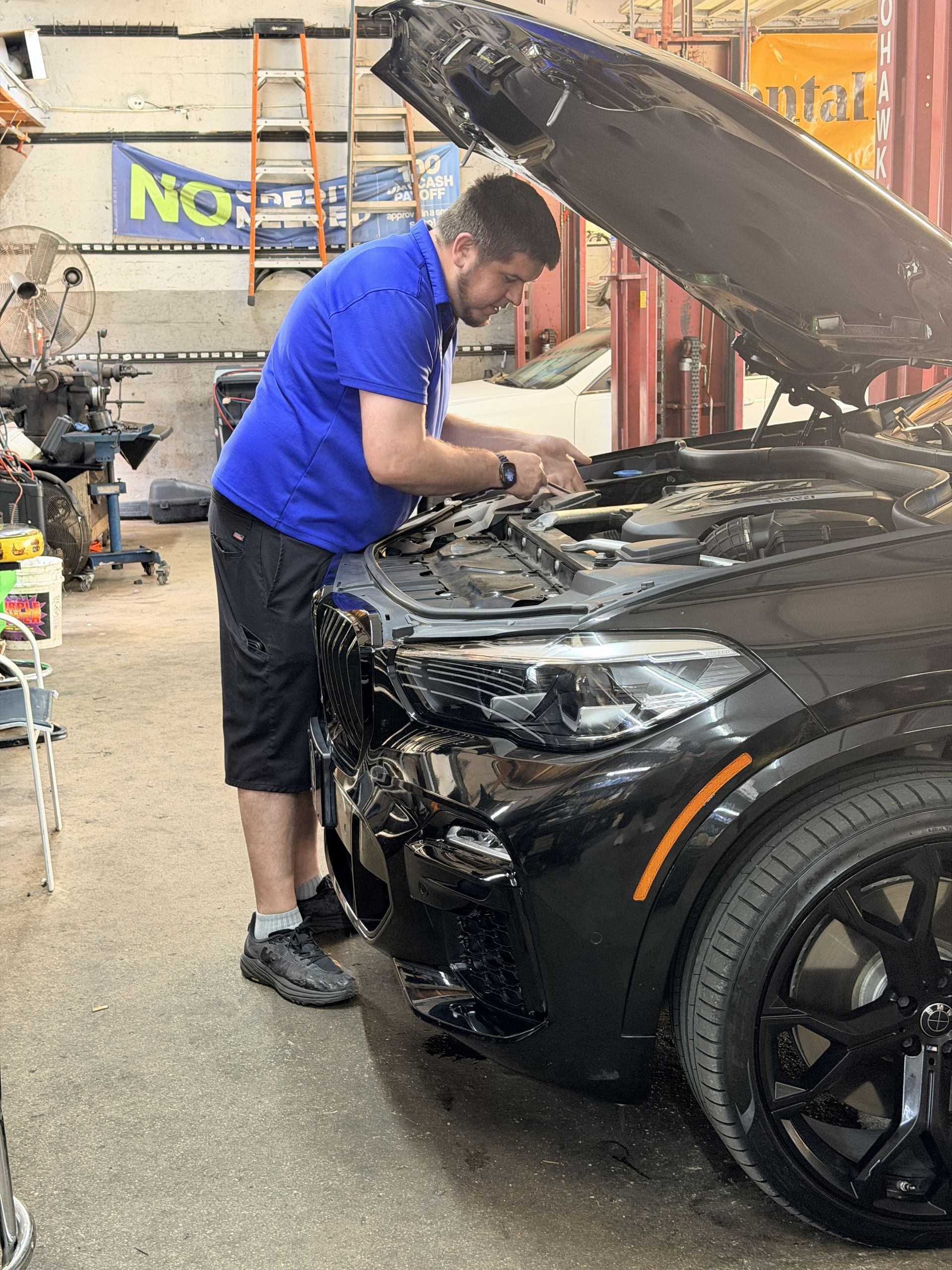 Mechanic working on car | Military Brake & Alignment Services Inc.