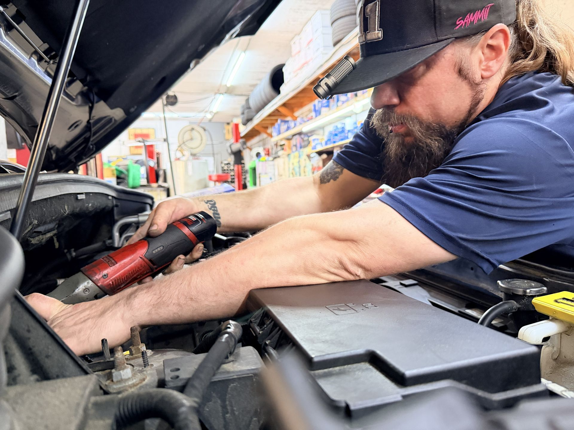 Mechanic working on a car | Military Brake & Alignment Services Inc.