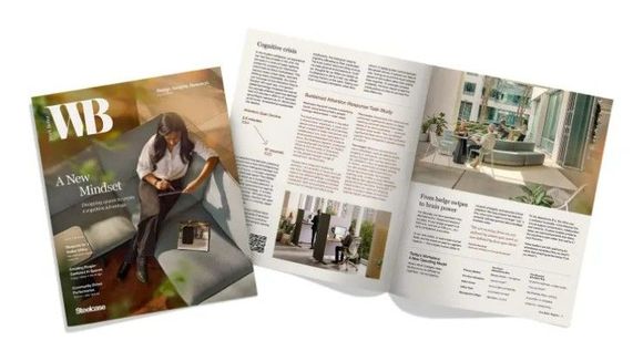 Open magazine brochure spread with interior design photos and text on a white background