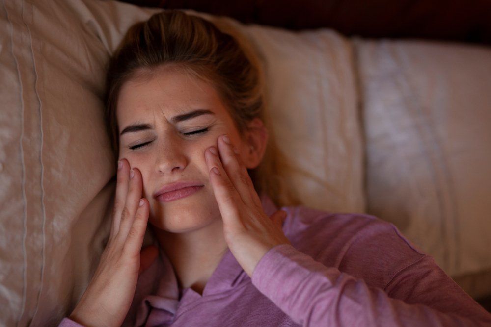 Woman With Jaw Pain — Dentistry Services in Cairns, QLD