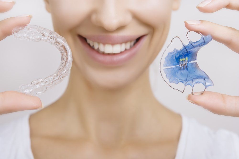 Girl Holding Retainer — Dentistry Services in Cairns, QLD