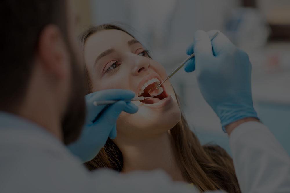 Dentist Examining Patient's Teeth — Dentistry Services in Cairns, QLD