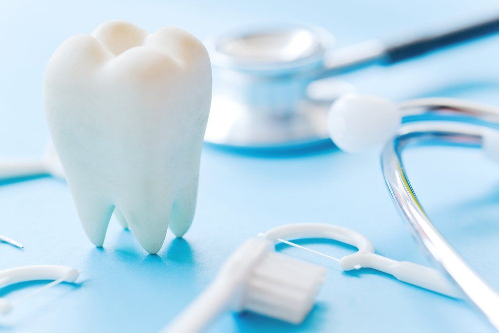 Floss Stick And Tooth Brush — Dentistry Services in Cairns, QLD