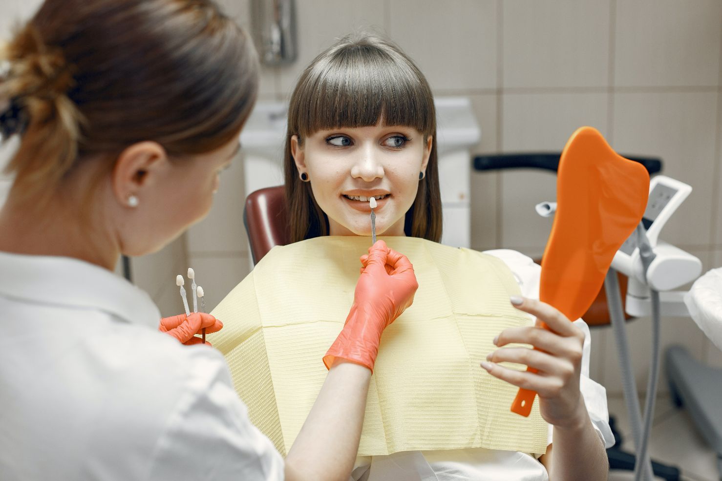 Comparing Tooth Veneer To Woman's Teeth — Dentistry Services in Cairns, QLD