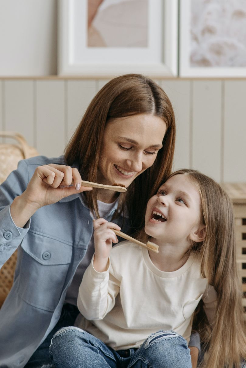 Mother with Her Daughter Brushing Their Teeth — Dentistry Services in Cairns, QLD