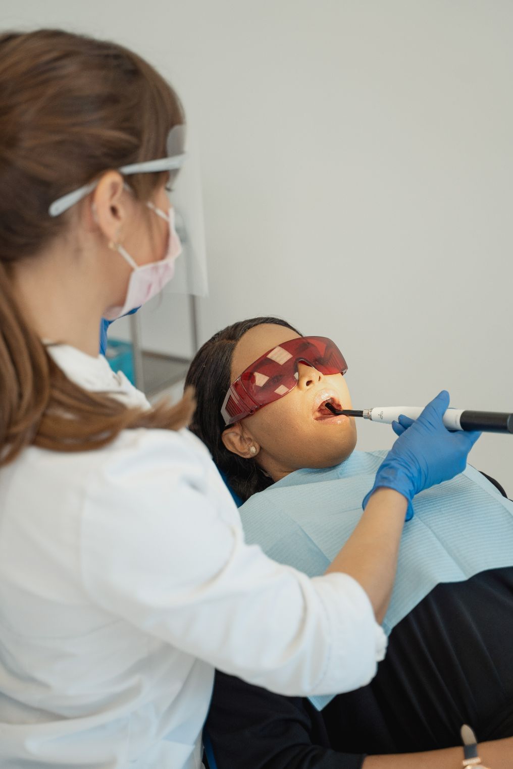 Dentist Checking Patient's Teeth — Dentistry Services in Cairns, QLD