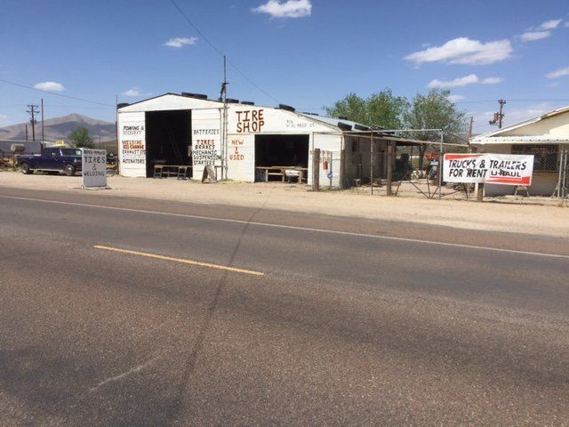 White building with open garage bays, 