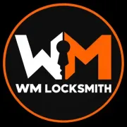 WM Locksmith logo with orange ring, white and orange text, and a keyhole in the center