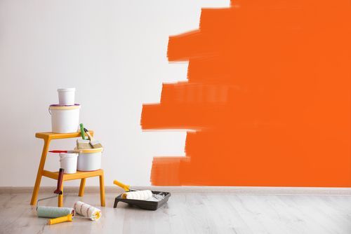 Decorator's Kit Of Tools And Paints Near Wall Indoors