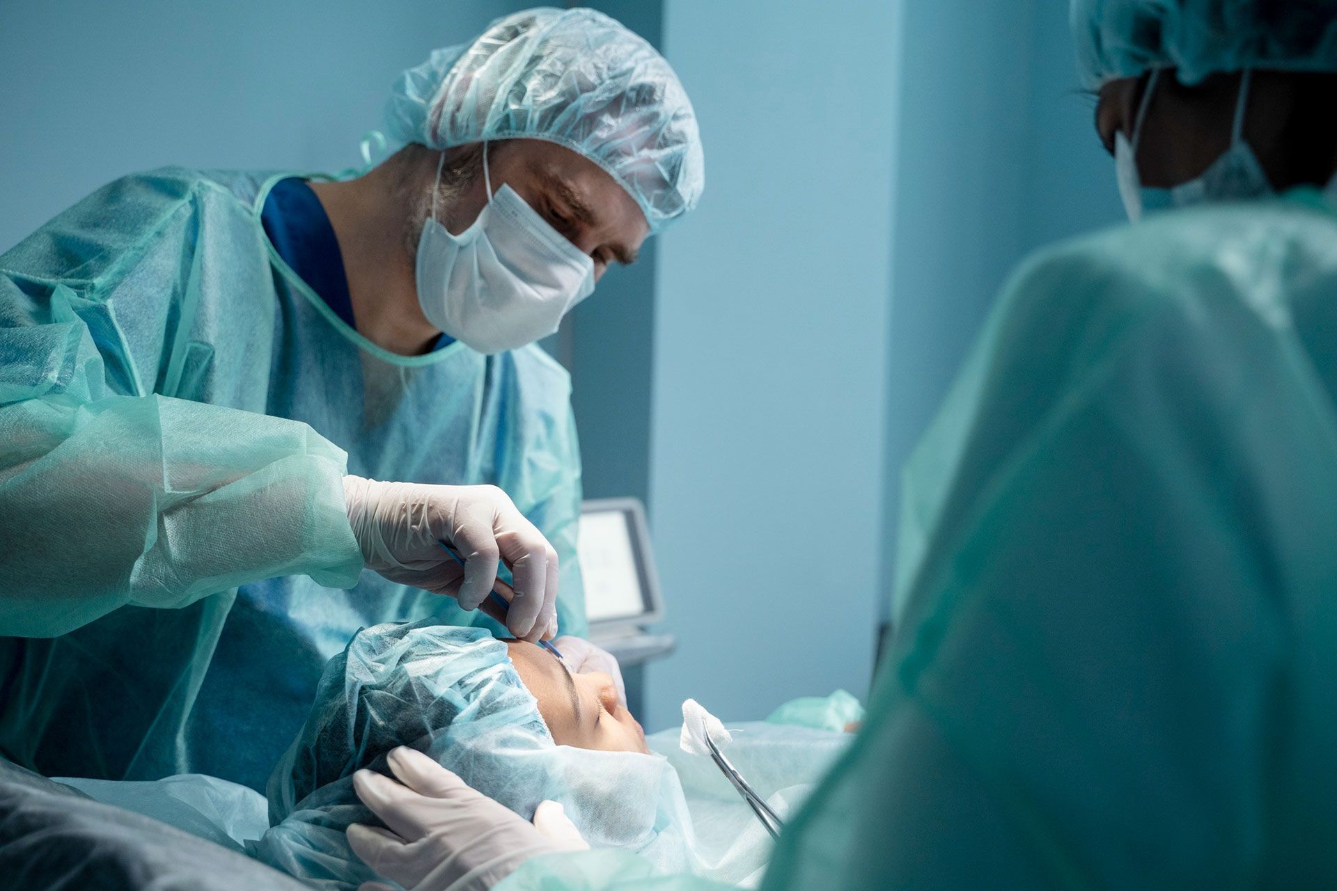 Another eye surgeon is operating on a patient in an operating room.