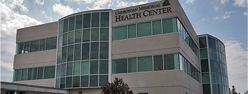 A large building with a lot of windows is a health center.