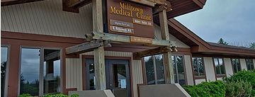A large wooden building with a sign on the front of it.