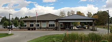 A large wooden building with a sign on the front of it.
