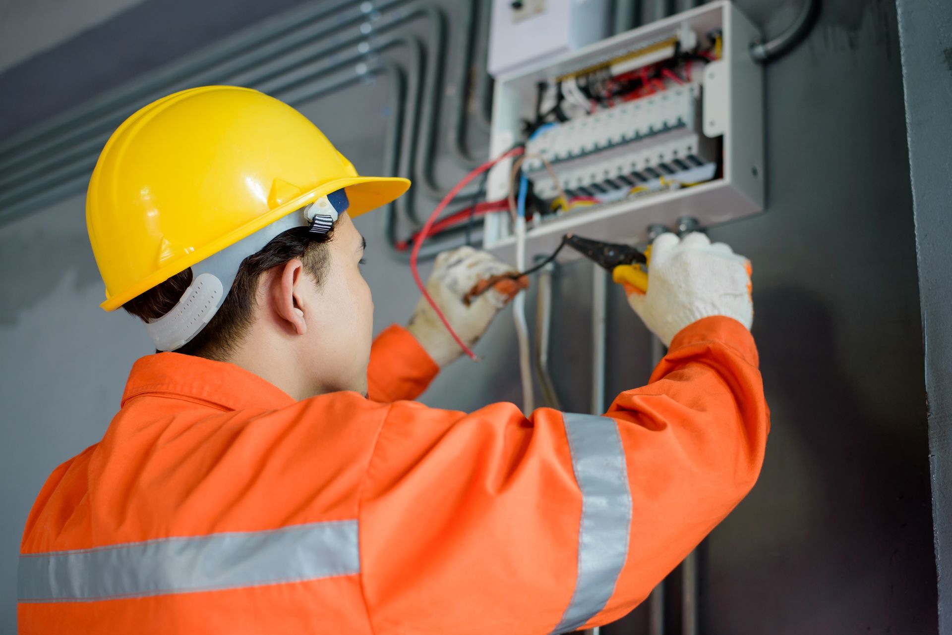 A man is working on an electrical system.