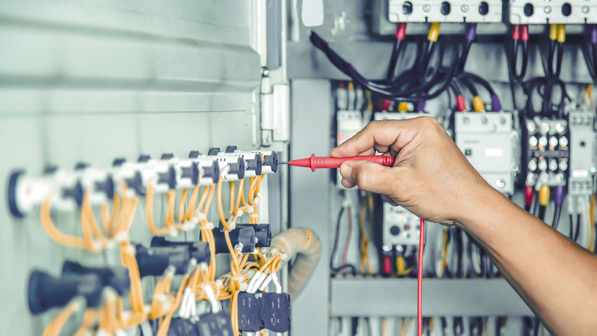 Commercial electrician from Impact Air & Electrical working on switchboard in Newcastle NSW Commercial electrician from Impact Air & Electrical working on switchboard in Newcastle NSW