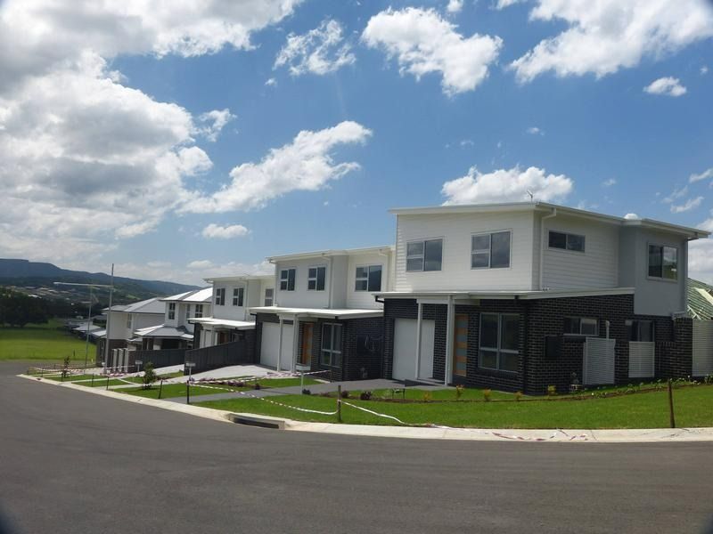 A Row of Houses on a Sunny Day — Sheps Roofing Service Pty Ltd In Albion Park Rail, NSW